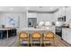 Bright kitchen featuring white cabinets, stainless steel appliances, and a speckled granite countertop at 8715 Wardle Ct, Raleigh, NC 27616