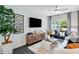 Cozy living room with stylish decor, a modern entertainment center, and large windows at 8715 Wardle Ct, Raleigh, NC 27616