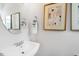 Elegant powder room featuring a modern sink, round mirror, and tasteful decor, enhancing the space's appeal at 8715 Wardle Ct, Raleigh, NC 27616