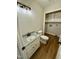 Neutral toned bathroom with a single sink vanity and an adjacent closet at 100 N 6Th St, Erwin, NC 28339