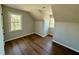 Attic bedroom with wood flooring and natural light from the two windows at 100 N 6Th St, Erwin, NC 28339