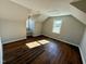 An attic bedroom with wood flooring and sunlight shining through the windows at 100 N 6Th St, Erwin, NC 28339