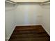 Empty walk in closet with wood floors, shelving and clothing rods at 100 N 6Th St, Erwin, NC 28339