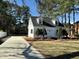 Inviting exterior view showcasing a two-story home with a long driveway and mature trees at 100 N 6Th St, Erwin, NC 28339