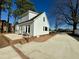 Side view of a two-story house with a brick patio that leads to a concrete driveway at 100 N 6Th St, Erwin, NC 28339