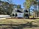 Charming exterior view of a two-story white home with dormer windows and a well-manicured lawn at 100 N 6Th St, Erwin, NC 28339