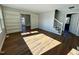Bright living room showcasing wood floors, built-in bookshelves, and a view into the backyard at 100 N 6Th St, Erwin, NC 28339