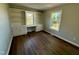 Home office with built-in shelving and cabinets and a view of the backyard at 100 N 6Th St, Erwin, NC 28339