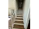 Newly renovated staircase with freshly painted railings and freshly stained wood steps at 100 N 6Th St, Erwin, NC 28339