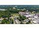 Vast aerial view of a town featuring residential areas, commercial buildings, and roadways surrounded by lush greenery at 1000 S 9Th St, Lillington, NC 27546