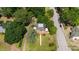 Aerial view of a well-maintained home with a large yard surrounded by lush greenery and neighborhood streets at 1000 S 9Th St, Lillington, NC 27546