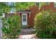 Back door entrance framed by green bushes leads into the home at 1000 S 9Th St, Lillington, NC 27546