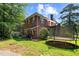 Spacious backyard features a trampoline and lush greenery, perfect for outdoor activities and Gathering fun at 1000 S 9Th St, Lillington, NC 27546