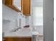 Classic bathroom featuring white fixtures, a wood vanity, and a view of the window at 1000 S 9Th St, Lillington, NC 27546