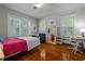 Bright bedroom with hardwood floors, large windows, and a functional desk area at 1000 S 9Th St, Lillington, NC 27546
