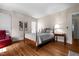Cozy bedroom featuring hardwood floors, soft lighting, and a comfortable bed at 1000 S 9Th St, Lillington, NC 27546