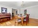 Elegant dining room with a set table, hardwood floors, and a piano at 1000 S 9Th St, Lillington, NC 27546