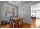 Bright dining area with a wooden table, white chairs, and natural light from large windows at 1000 S 9Th St, Lillington, NC 27546