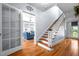 Inviting entryway with hardwood floors, a staircase, and a glimpse into the bright living room at 1000 S 9Th St, Lillington, NC 27546
