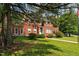 Beautiful brick home with mature landscaping showcases a well-maintained lawn and classic architectural details at 1000 S 9Th St, Lillington, NC 27546