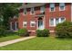Charming two-story red brick home with a light blue front door and meticulously maintained landscaping at 1000 S 9Th St, Lillington, NC 27546