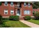 Charming two-story red brick home with a light blue front door and manicured shrubs at 1000 S 9Th St, Lillington, NC 27546