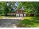 Spacious two-car garage with a basketball hoop and carport offers plenty of parking and activity space at 1000 S 9Th St, Lillington, NC 27546