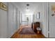 Hallway with wood floors, fresh white walls, and a vintage rug leading to a bright window at 1000 S 9Th St, Lillington, NC 27546