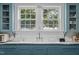 Charming kitchen with blue cabinets, subway tile backsplash, and a large sink under bright windows at 1000 S 9Th St, Lillington, NC 27546