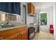 A quaint kitchenette featuring a stainless sink, and window with a window air conditioner at 1000 S 9Th St, Lillington, NC 27546