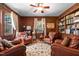 Cozy living room with wood paneling, comfortable leather chairs, and built-in bookshelves at 1000 S 9Th St, Lillington, NC 27546