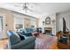 Inviting living room featuring a fireplace, hardwood floors, and large windows for ample natural light at 1000 S 9Th St, Lillington, NC 27546
