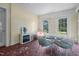 Bright sunroom with unique tile flooring, an electric fireplace, and a seating area at 1000 S 9Th St, Lillington, NC 27546
