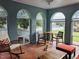 Inviting sunroom with arched windows, brick walls, and mosaic tile flooring for a relaxing space at 1000 S 9Th St, Lillington, NC 27546