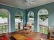 Bright sunroom featuring arched windows, brick accent walls, and comfortable seating, perfect for relaxation at 1000 S 9Th St, Lillington, NC 27546