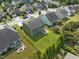 Home's spacious backyard includes lush lawn with a basketball hoop, patio, and privacy fence at 1021 Traditions Meadow Dr, Wake Forest, NC 27587