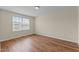 Bright bedroom with wood-look flooring and a window offering natural light at 1021 Traditions Meadow Dr, Wake Forest, NC 27587