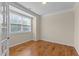 Neutral bedroom featuring hardwood floors, crown molding, window with blinds and natural light at 1021 Traditions Meadow Dr, Wake Forest, NC 27587