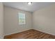 Bedroom with wood-look floors, light-colored walls, and a window with blinds at 1021 Traditions Meadow Dr, Wake Forest, NC 27587