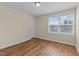 Bright bedroom with wood-look flooring and a window offering natural light at 1021 Traditions Meadow Dr, Wake Forest, NC 27587