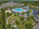 Aerial view of community pool features a playground, amphitheater and sand volleyball court at 1021 Traditions Meadow Dr, Wake Forest, NC 27587