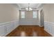 Dining room with chair rail molding and chandelier, featuring wood floors at 1021 Traditions Meadow Dr, Wake Forest, NC 27587