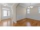 Dining area featuring wainscoting, chair rail molding, hardwood floors and a modern chandelier at 1021 Traditions Meadow Dr, Wake Forest, NC 27587
