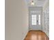 Hallway with a double door and wood flooring, leading to more rooms at 1021 Traditions Meadow Dr, Wake Forest, NC 27587