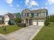 Charming two-story home with a manicured lawn, a two-car garage, and beautiful curb appeal at 1021 Traditions Meadow Dr, Wake Forest, NC 27587