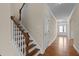 Hallway with hardwood floors, staircase, crown molding, and access to front entrance at 1021 Traditions Meadow Dr, Wake Forest, NC 27587