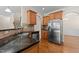 Kitchen area featuring granite counters, tile backsplash, and wood cabinetry at 1021 Traditions Meadow Dr, Wake Forest, NC 27587