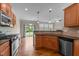 Open kitchen with stainless steel appliances, backsplash, hardwood floors, granite countertop at 1021 Traditions Meadow Dr, Wake Forest, NC 27587