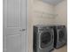 A functional laundry room with modern appliances and wire shelving at 1021 Traditions Meadow Dr, Wake Forest, NC 27587