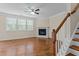 Spacious living room with hardwood floors, a fireplace, large window, and crown molding at 1021 Traditions Meadow Dr, Wake Forest, NC 27587